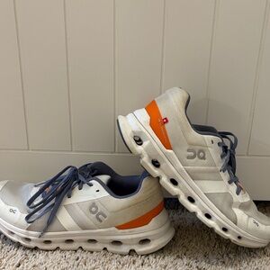 On Running Sneakers with White and Orange Accents